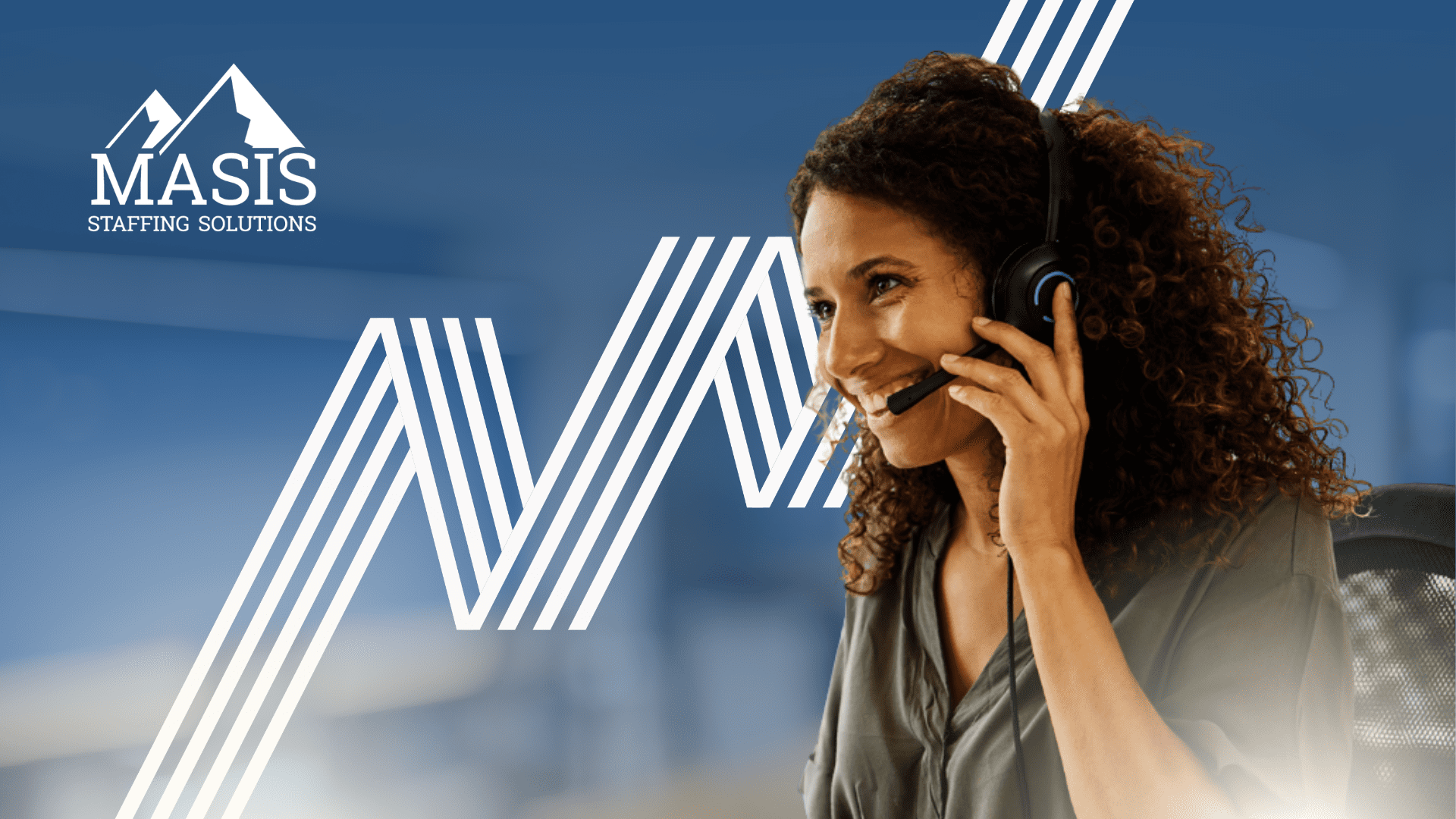 A woman talking on a phone in an office.
